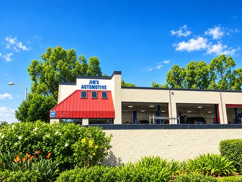 Wide view of the Jim's Automotive building and green landscaping in the Huntington Beach Autopark center