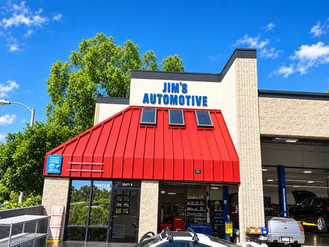 Jim's Automotive Specialties storefront with its red metal awning and blue Jim's Automotive sign on Repair Ln in Huntington Beach, CA