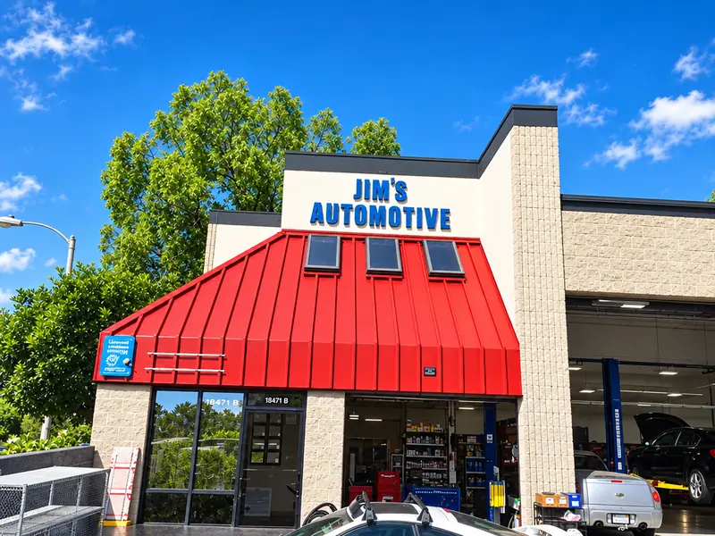 Jim's Automotive Specialties storefront with its red metal awning and blue Jim's Automotive sign on Repair Ln in Huntington Beach, CA